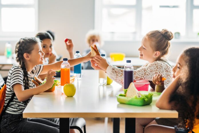 Adorable,Schoolgirls,Taking,Lunch,At,School,Cafeteria