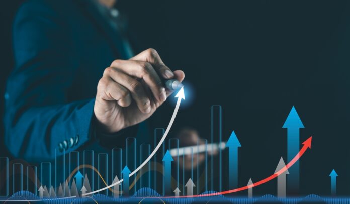 A,Business,Person,Draws,Upward,Arrows,And,Graphs,,Symbolizing,Growth,